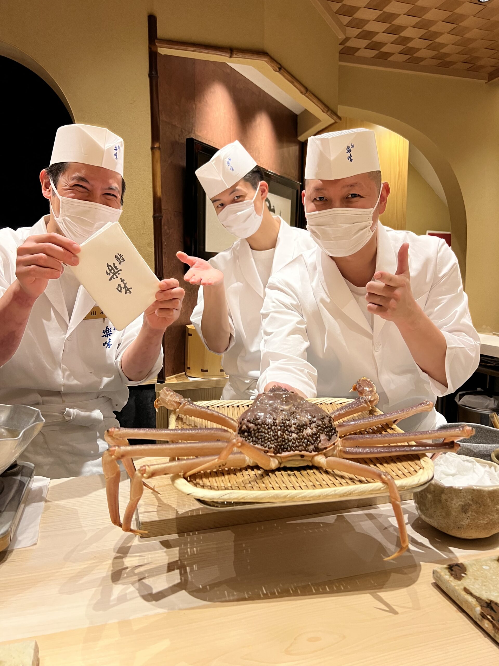 Sushi chefs with live Japanese crab